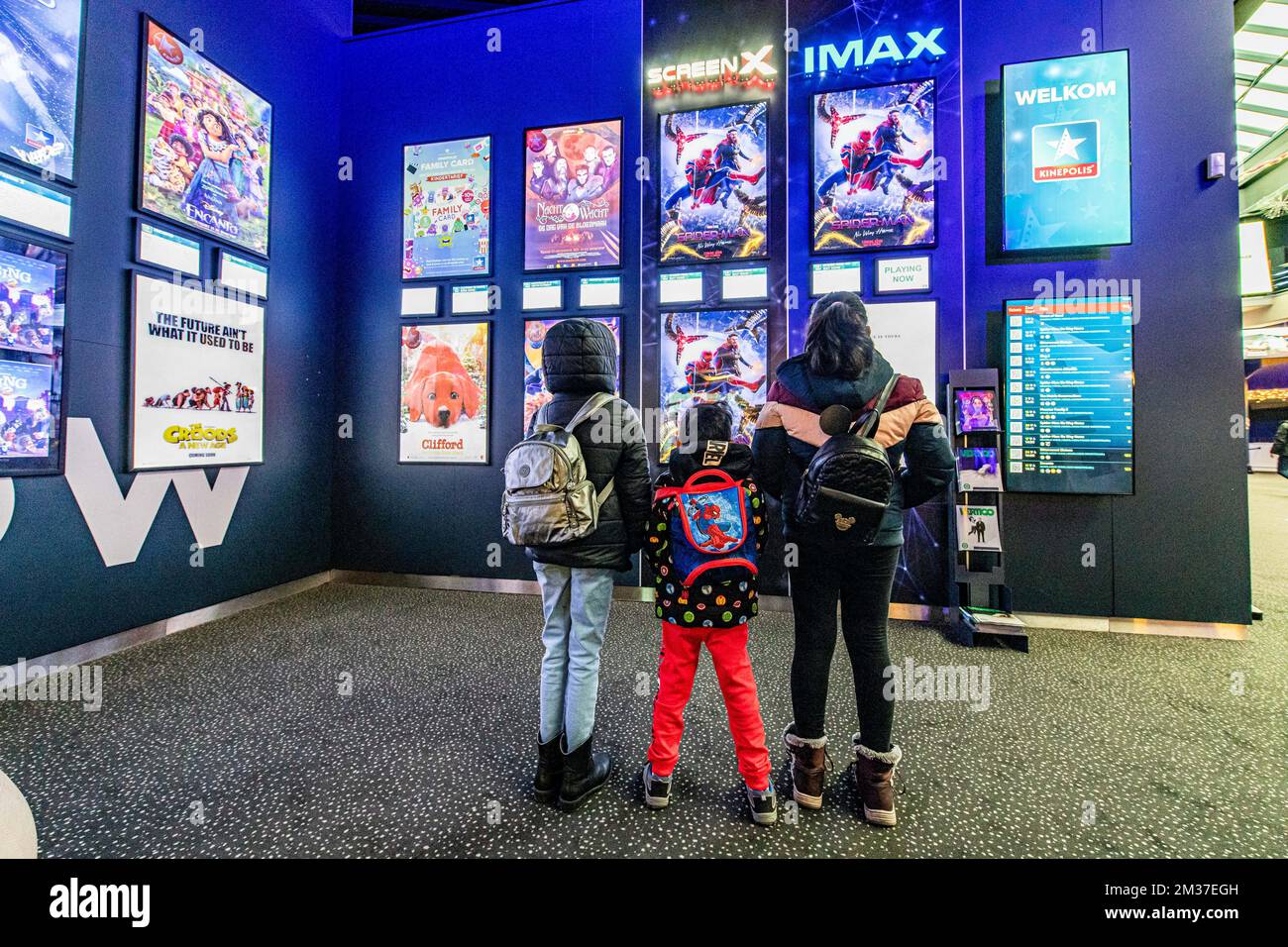 Illustration picture shows kids looking at a Spiderman poster at a Kinepolis cinema in Antwerp, Friday 24 December 2021. Kinepolis has scheduled additional screenings of the latest 'Spider-Man' film. Cinemas will have to close their doors again from Sunday due to the corona pandemic. BELGA PHOTO JONAS ROOSENS Stock Photo