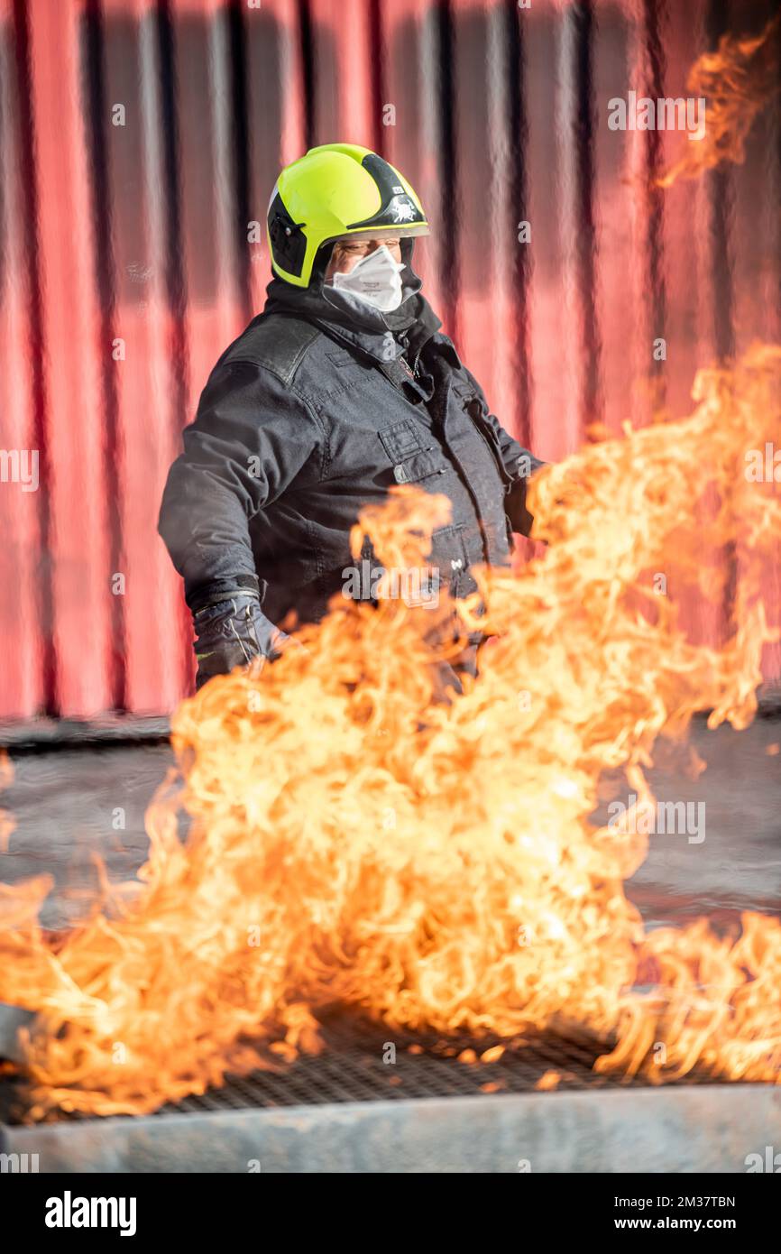 Virologist professor Marc Van Ranst (yellow helmet) pictured during a symbolic action entitled 'Marc Van Ranst extinguishes a worldwide fire' by We Social Movements, in Mendonk, Monday 17 January 2022. A fire drill will take place this afternoon with professor Marc Van Ranst as the 'firefighter'. This is an action in support of the European citizens' initiative 'No Profit on Pandemic', which calls on the European Commission to speak out in the World Trade Organization for the suspension of patents on corona vaccines and medicines. According to the initiators, this is the first step to drastica Stock Photo
