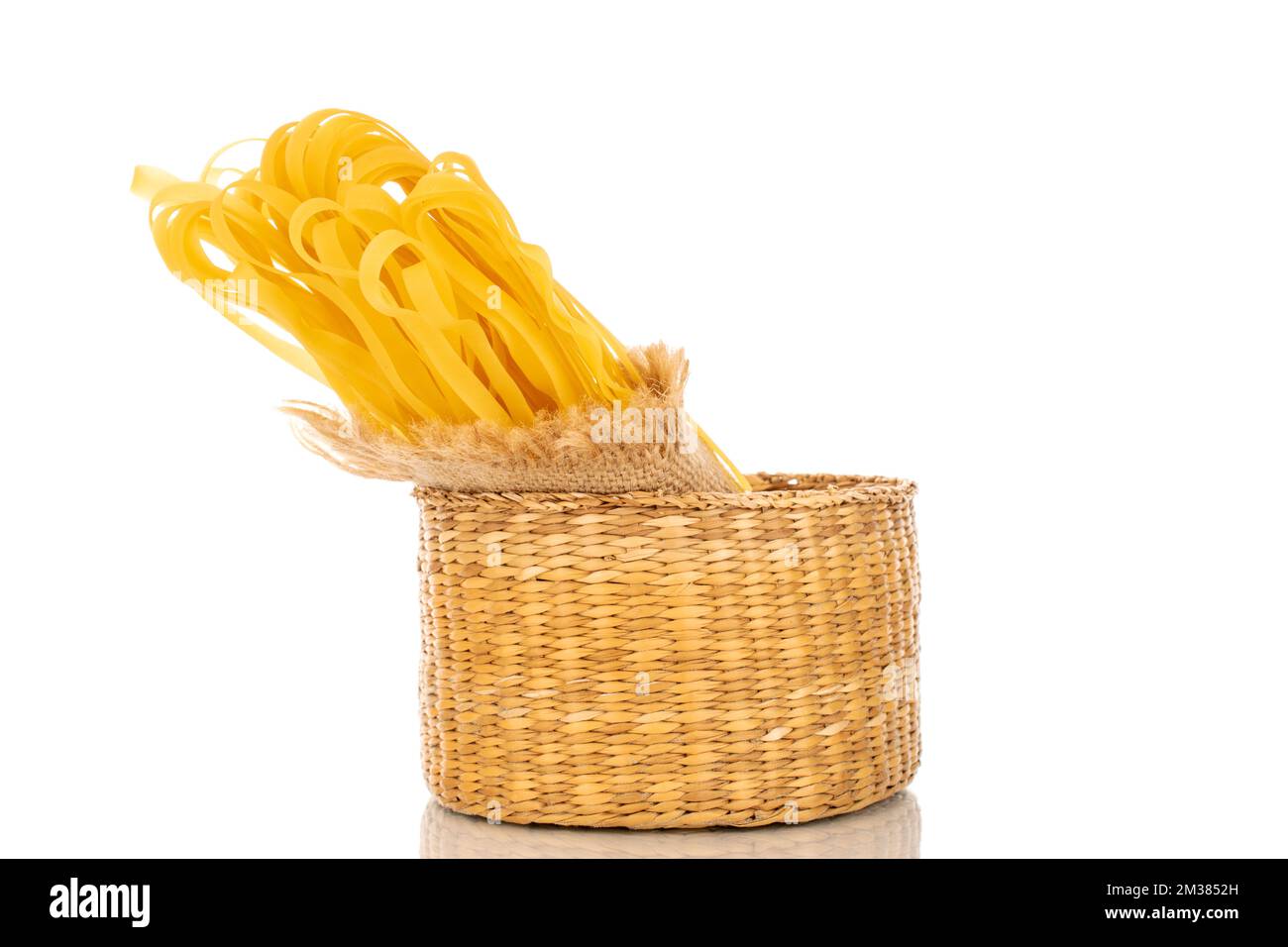 https://c8.alamy.com/comp/2M3852H/homemade-raw-noodles-in-a-straw-bowl-macro-isolated-on-white-background-2M3852H.jpg