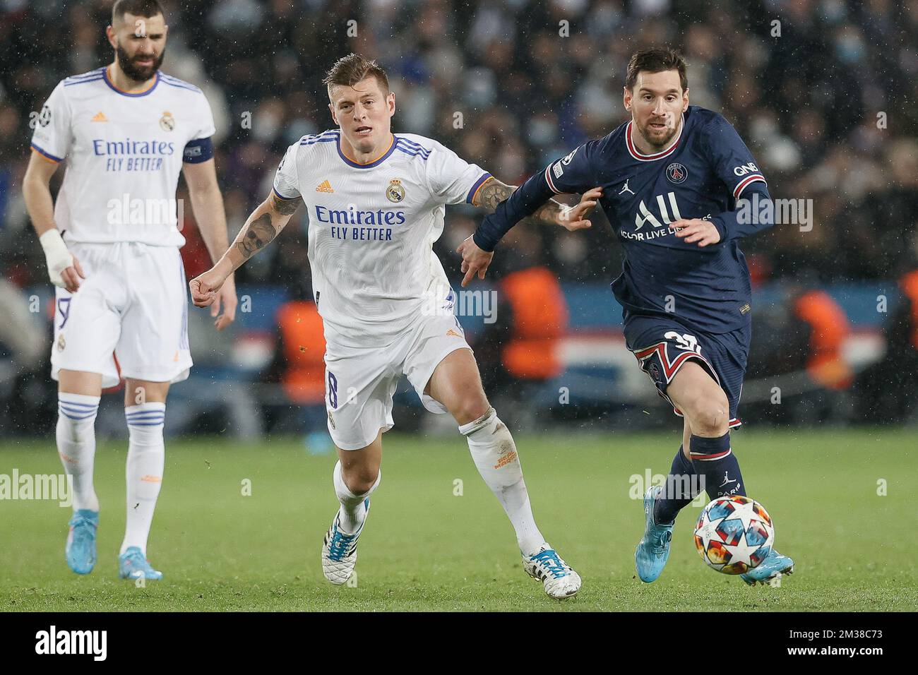 Real's Toni Kroos and PSG's Lionel Messi fight for the ball during a soccer game between French club Paris Saint-Germain and Spanish club Real Madrid, Tuesday 15 February 2022 in Paris, in the round of sisteen (1/8 final) of the UEFA Champions League. BELGA PHOTO BRUNO FAHY Stock Photo