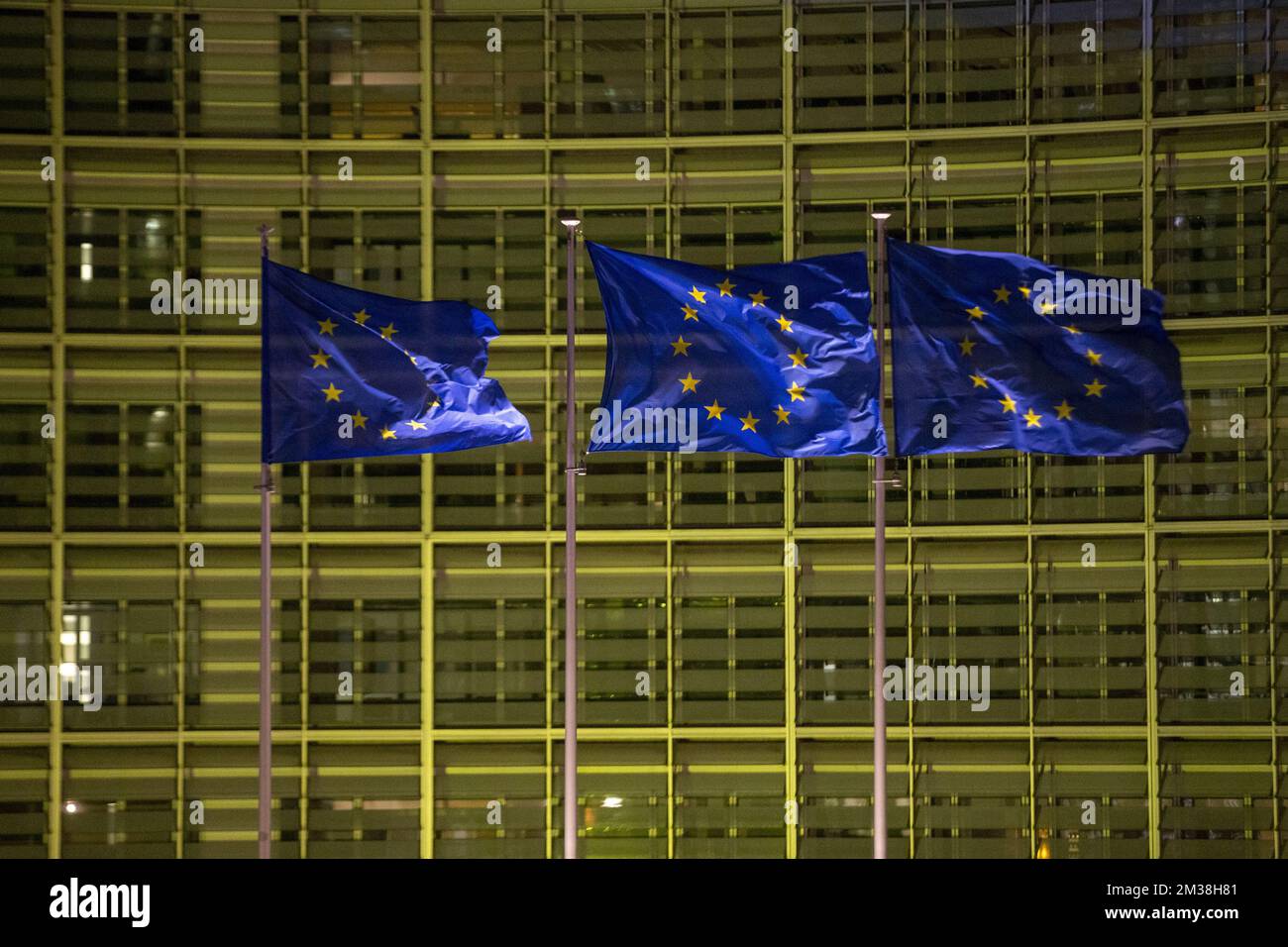 Illustration picture shows European flags fly in front of the Berlaymont building, housing the European Commission headquarters, that has been illuminated in the colours of the Ukrainian flag, to show support for the Ukrainian people, in Brussels, Thursday 24 February 2022. Last night, Russia decided to invade several Ukrainian regions. BELGA PHOTO NICOLAS MAETERLINCK  Stock Photo