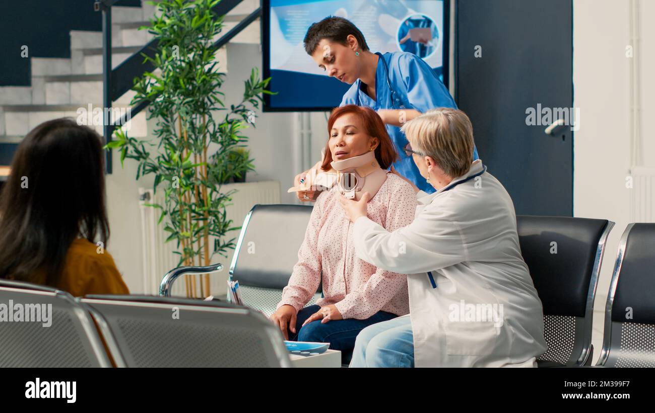 Diverse medical staff helping woman with cervical collar, removing neck