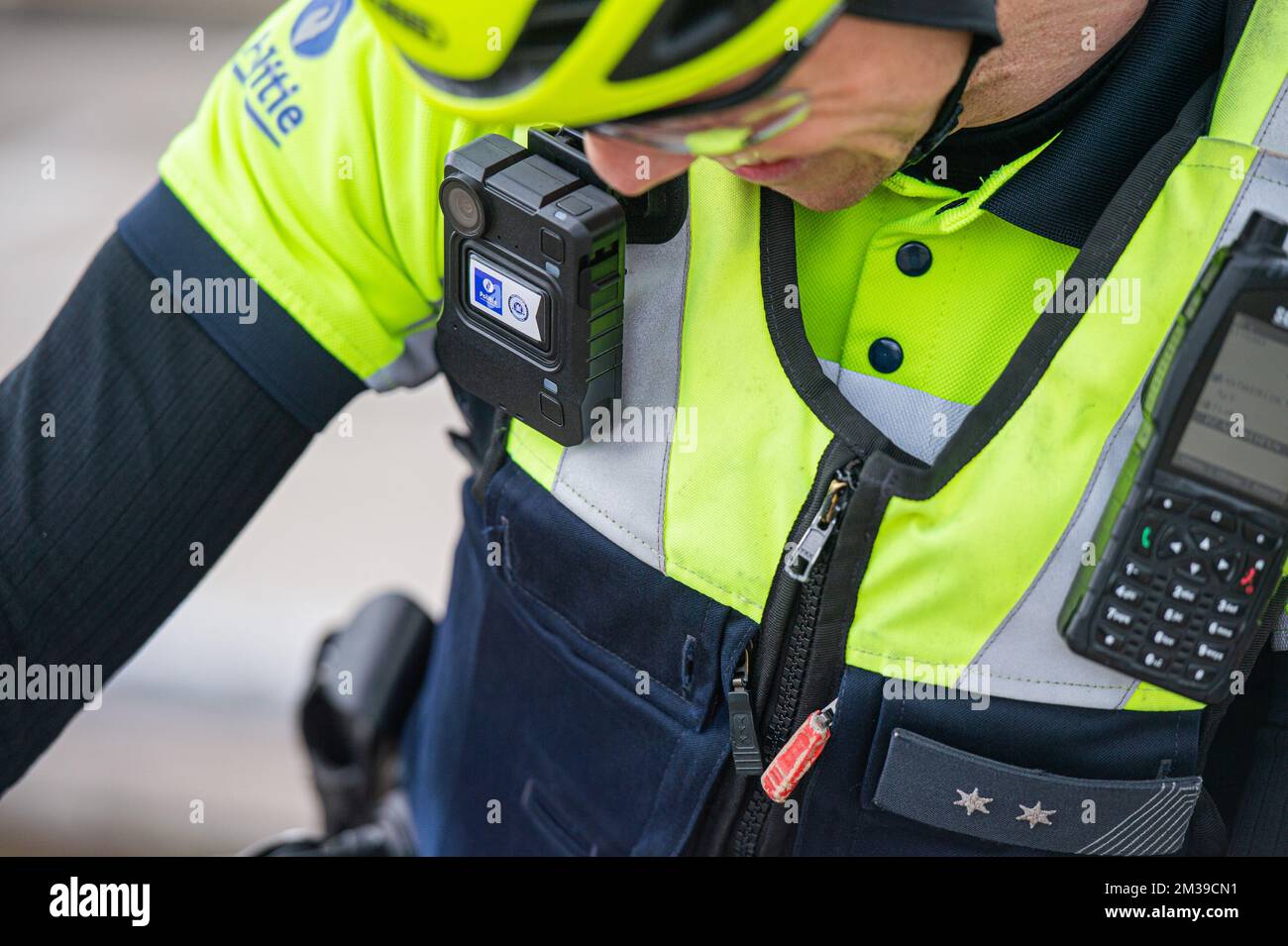 Illustration image shows a police officer wearing a bodycam during a