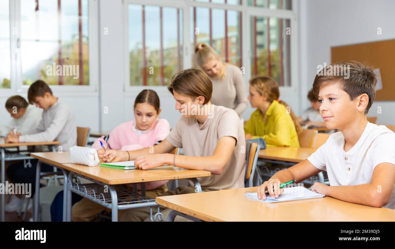 Portrait of teenage schoolgirl sitting on lesson in classroom Stock ...