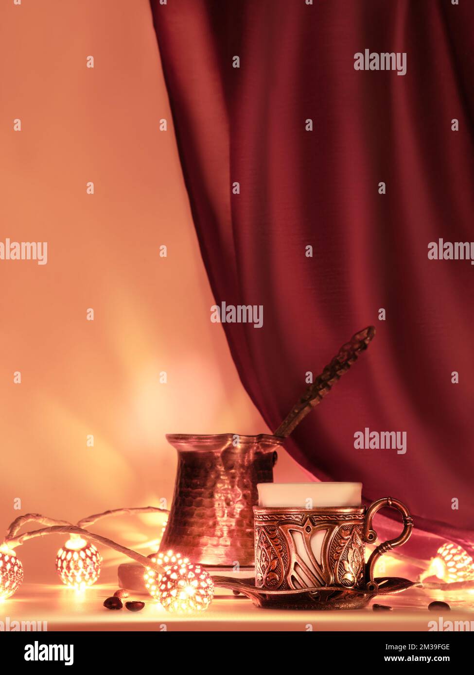 Turkish coffee pot and traditional cup with oriental sweets. Ornate copper metal garland and tea