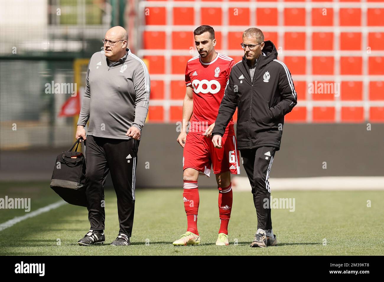 Standard's Noe Dussenne leaves the pitch after being injured during a
