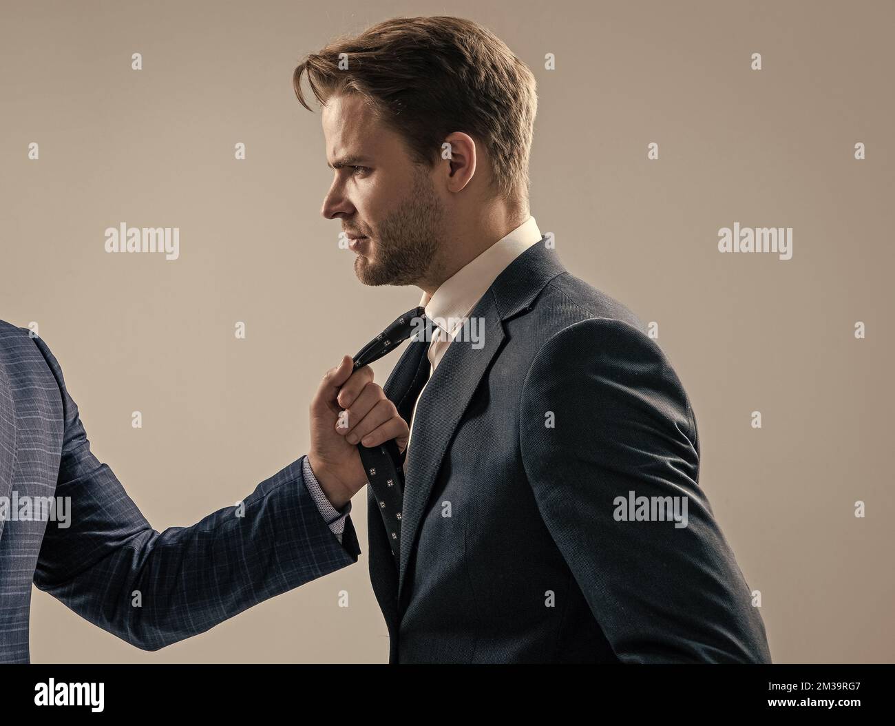 Conflict at work. Employee being pulled by necktie. Physical conflict. Workplace aggression Stock Photo