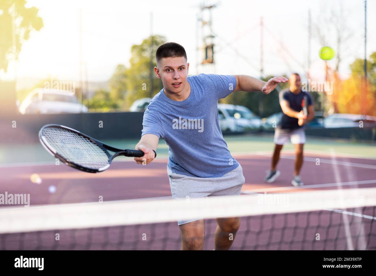 Boy tennis player training on court Stock Photo Alamy