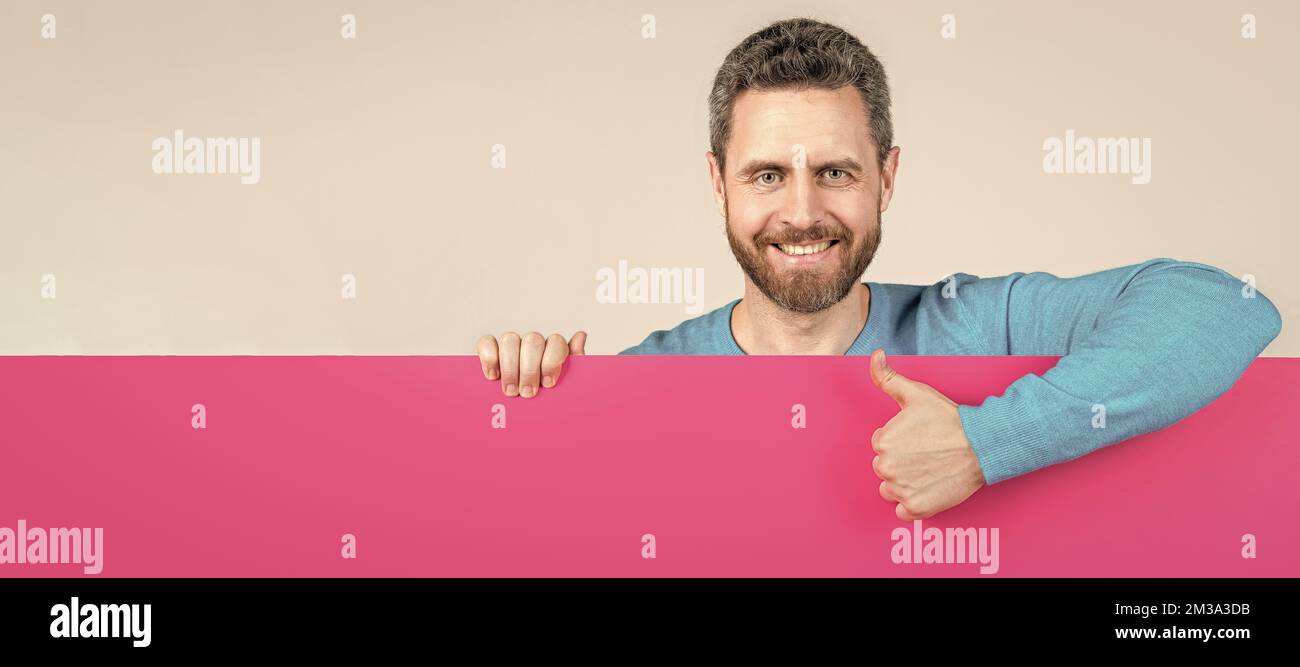 Man face portrait, banner with copy space. happy man behind blank paper ...
