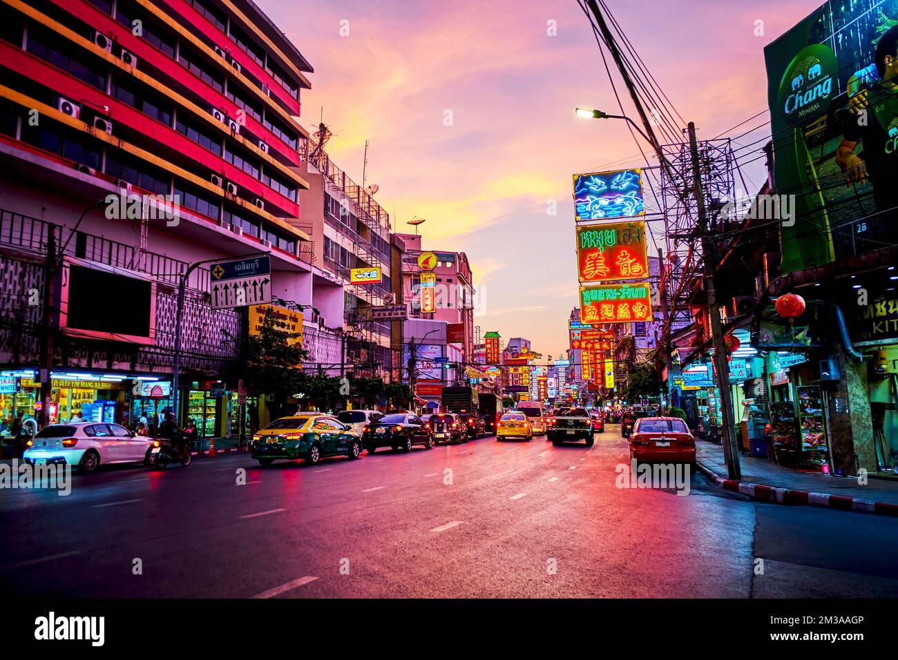 BANGKOK, THAILAND - APRIL 23, 2019: Late evening in Chinatown on Yaowarat Road with numerous bright signboards, showcases and driving cars, on April 2 Stock Photo