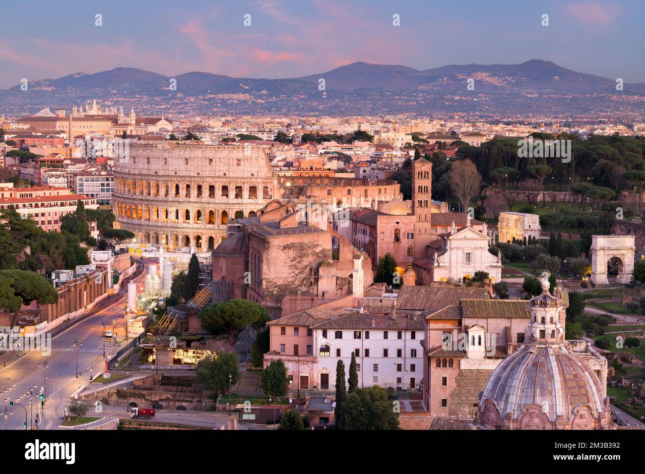 Rome, Italy view towards the Colosseum with archeological areas at sunset. Stock Photo