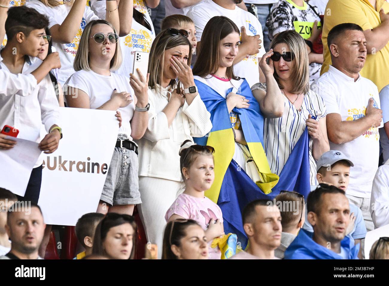 Fans are emotional during the national anthem of Ukraine ahead of a friendly soccer game between Belgian Royal Antwerp FC and Ukrainian FC Dynamo Kyiv, Friday 15 July 2022 in Antwerp. BELGA PHOTO TOM GOYVAERTS Stock Photo