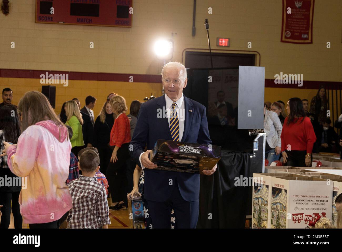 Arlington, United States. 12 December, 2022. U.S. President Joe Biden carries toys during the 75th anniversary Toys for Tots sorting at Joint Base Myer-Henderson Hall, December 12, 2022 in Arlington, Virginia.  Credit: Sgt. Ellen Schaaf/US Marine Corps/Alamy Live News Stock Photo