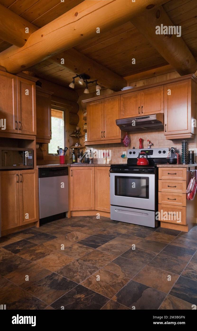 Wooden shaker style and modern appliances in kitchen with