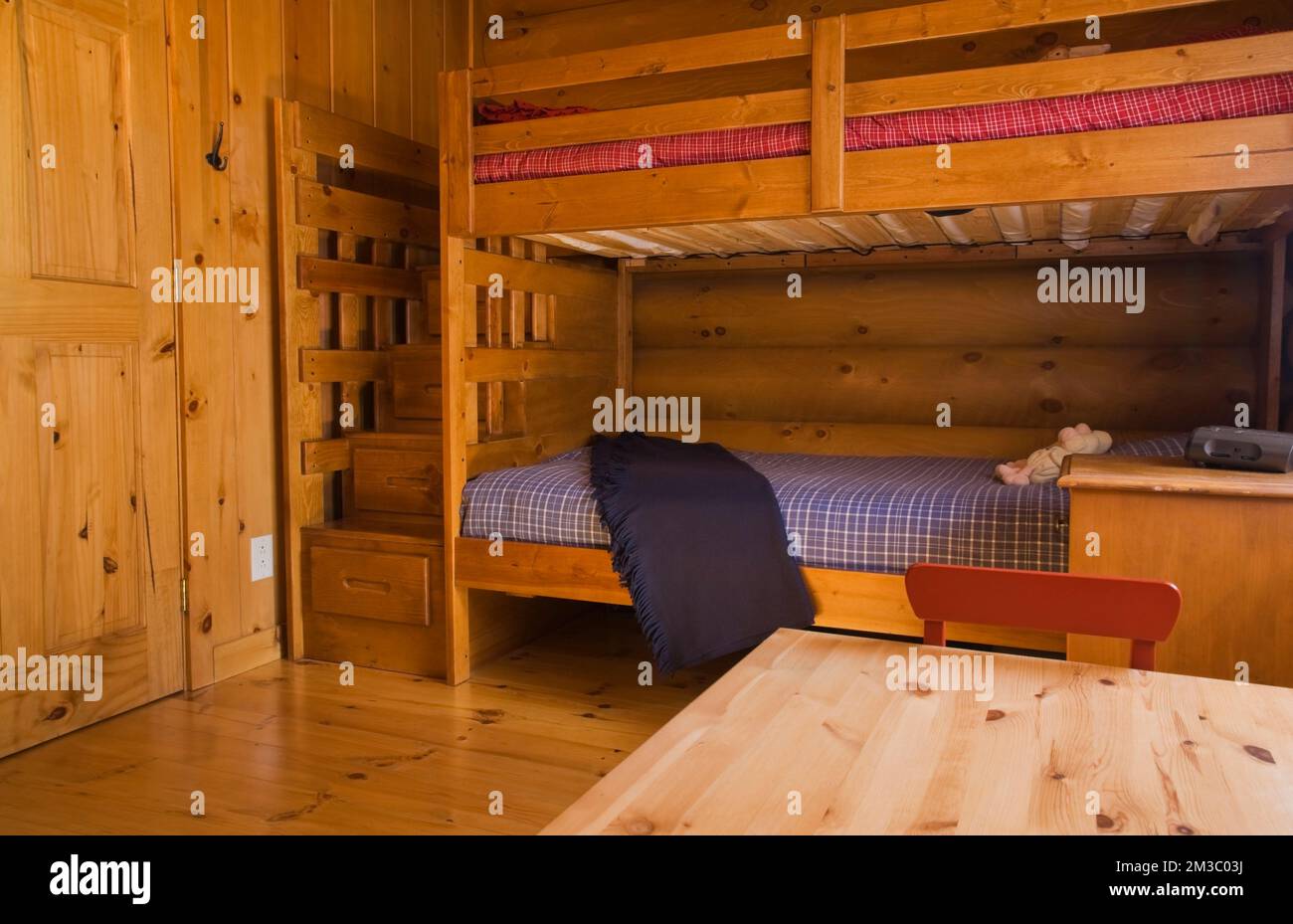 Bunk beds in children's bedroom inside log cabin, Quebec, Canada. This