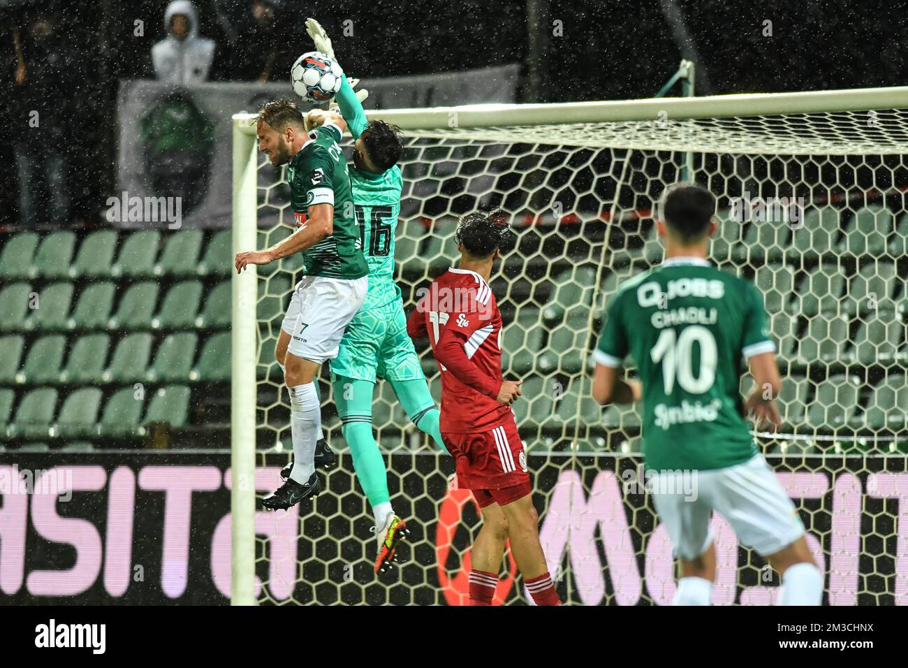 Lommel's Robin Henkens and SL16's goalkeeper Tom Poitoux pictured in action during a soccer