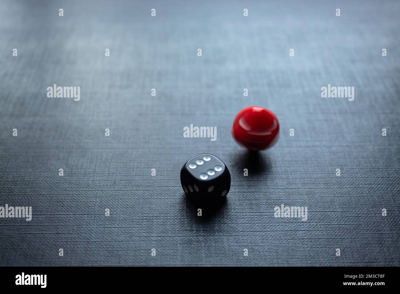 Closeup to a dices, one dice is red and one black dice is spinning over