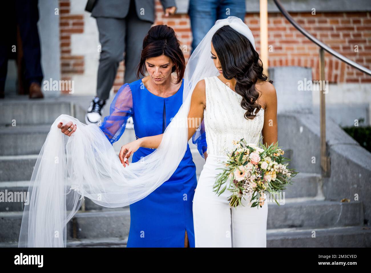Remco's mother Agna Van Eeckhout helps Evenepoel's partner Oumaima Oumi Rayane with the long veil, ahead of the wedding of Belgian cyclist Remco Evenepoel and Oumi Rayane, Sunday 02 October 2022 in Dilbeek, Belgium. BELGA PHOTO JASPER JACOBS  Stock Photo
