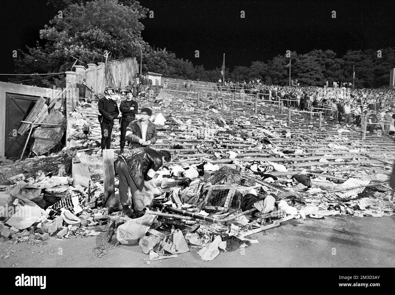 Belgian policemen and volunteers clear the scene after a disastrous