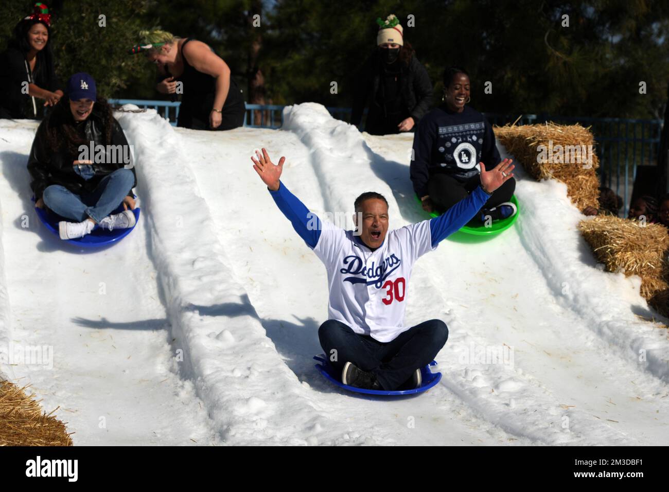 Los Angeles, United States. 14th Dec, 2022. Emme Roberts (the daughter of  Los Angeles Dodgers manager Dave Roberts), left, Roberts and Dodgers  Foundation chief executive officer Nichol Whitman slide down a snow