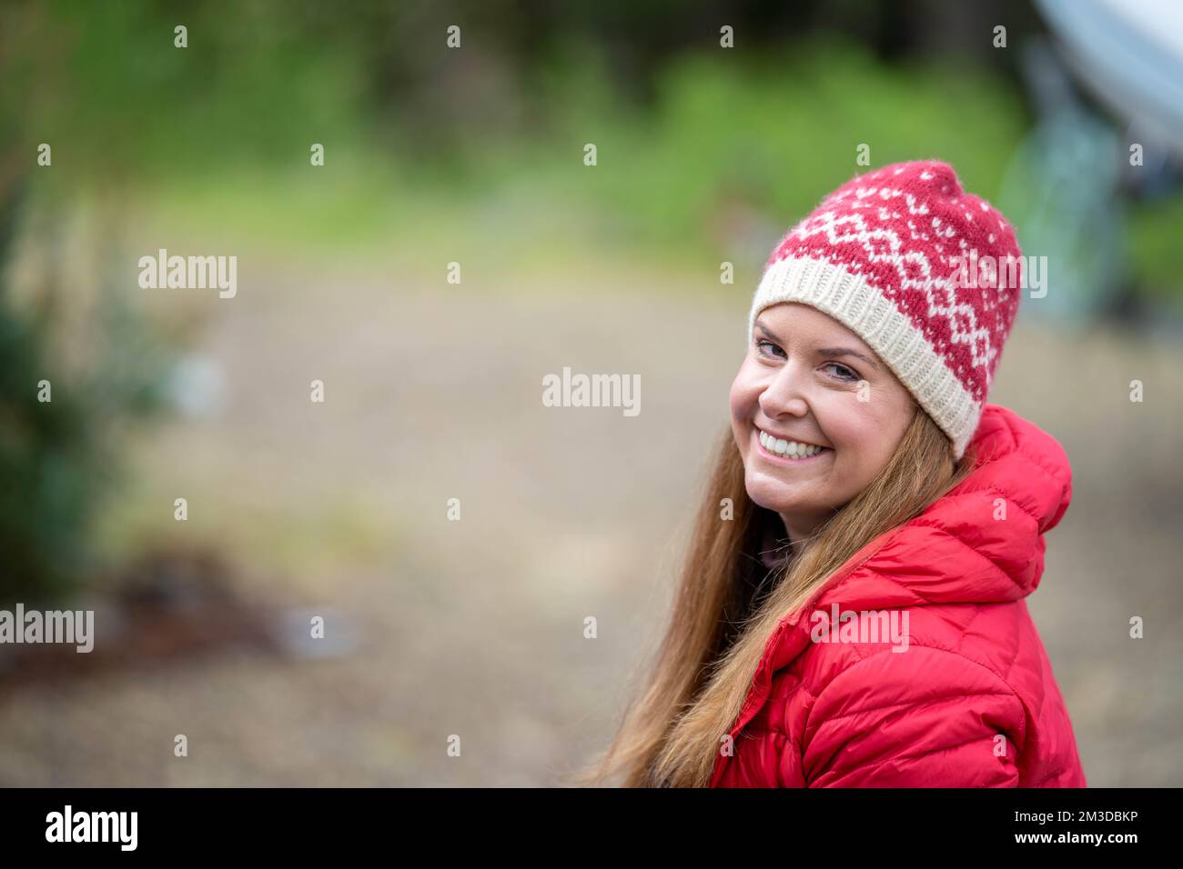 woman folding up a tarp at a campground in australia. camping tant and