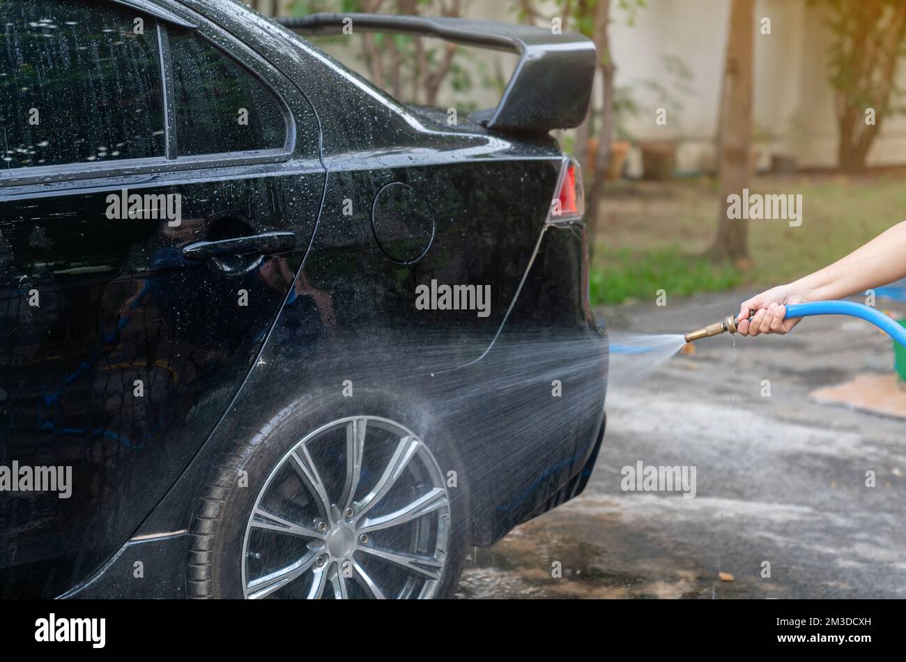 Car washing. Cleaning Car wheel Using High Pressure Water Stock Photo