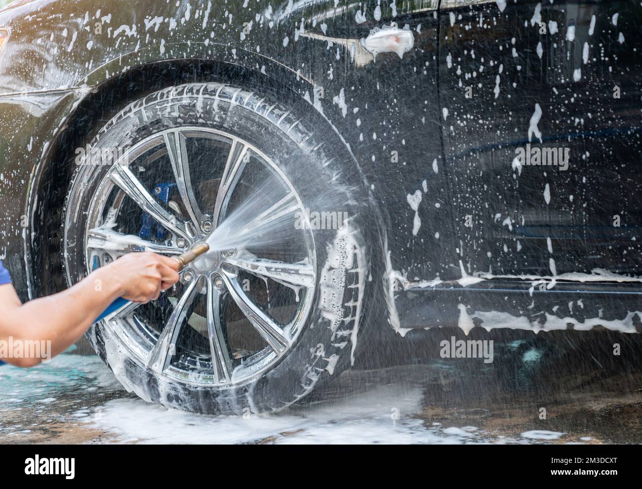 Manual car wash with pressurized water home outdoor. Spray cleanning