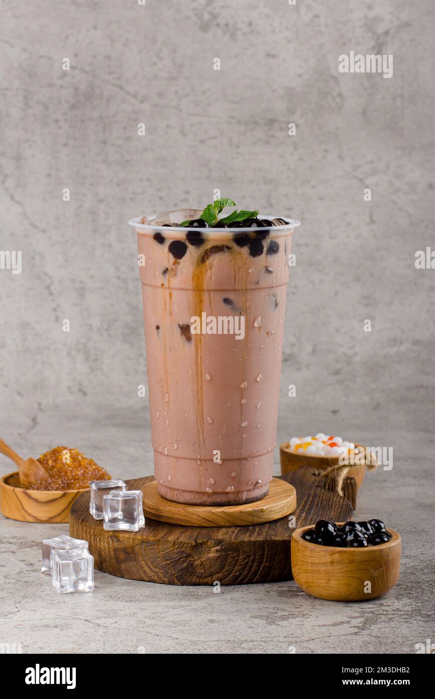 https://c8.alamy.com/comp/2M3DHB2/boba-or-tapioca-pearls-is-taiwan-bubble-milk-tea-in-plastic-cup-with-chocolate-mint-flavor-on-texture-background-summers-refreshment-2M3DHB2.jpg