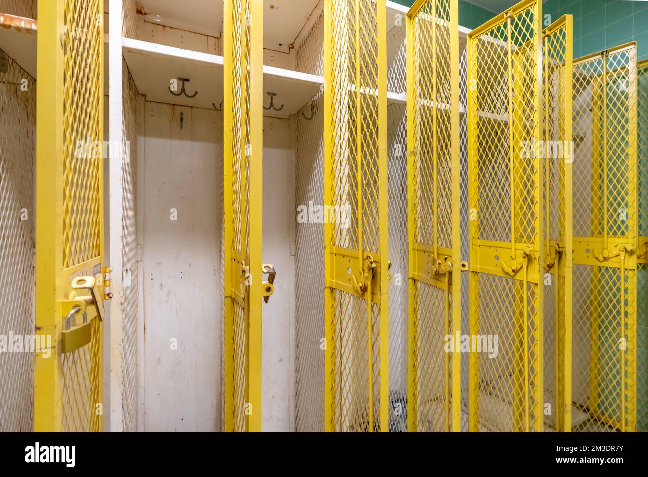 Old yellow metal gym, gymnasium, lockers with an old locker room Stock