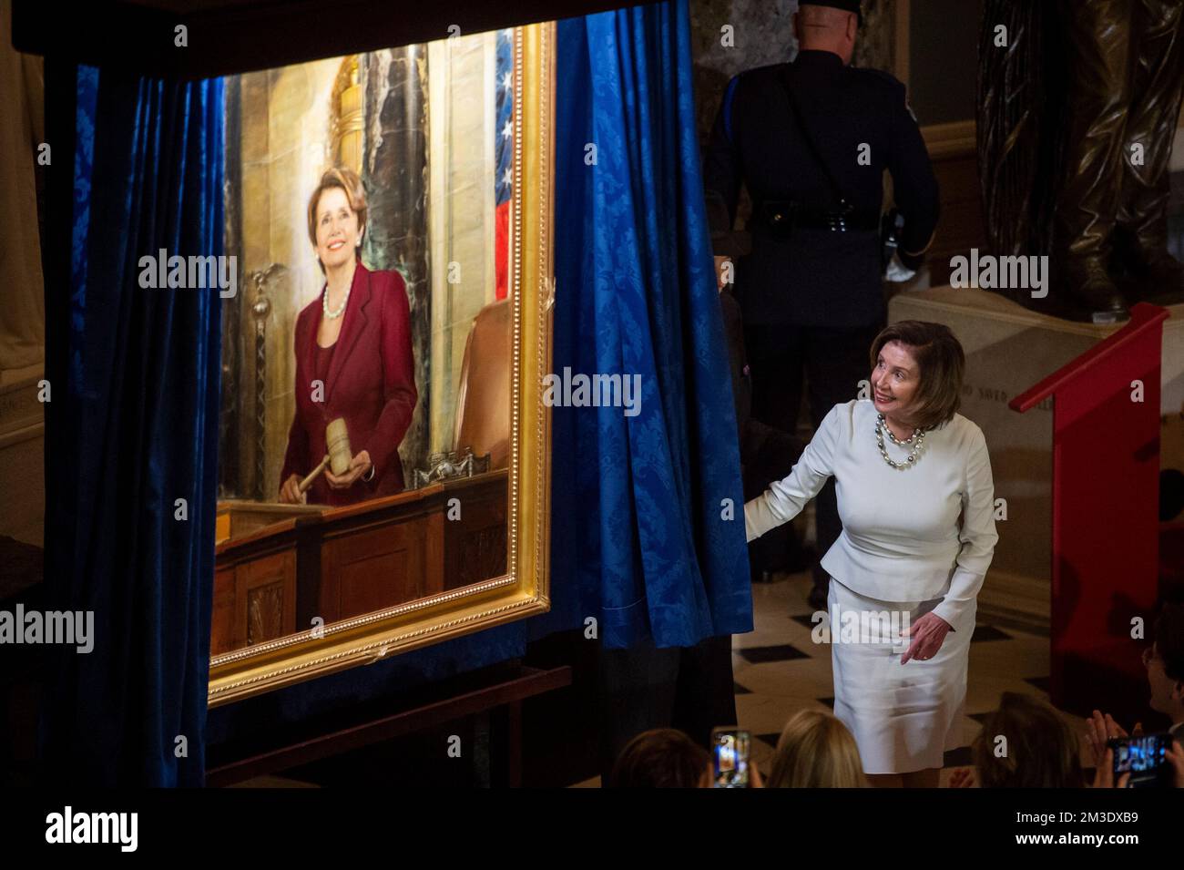 Washington, Vereinigte Staaten. 14th Dec, 2022. Speaker of the United States House of Representatives Nancy Pelosi (Democrat of California) is joined by her husband Paul Pelosi as she draws back the curtain to unveil her official portrait in Statuary Hall at the US Capitol in Washington, DC, Wednesday, December 14, 2022. Credit: Rod Lamkey/CNP/dpa/Alamy Live News Stock Photo