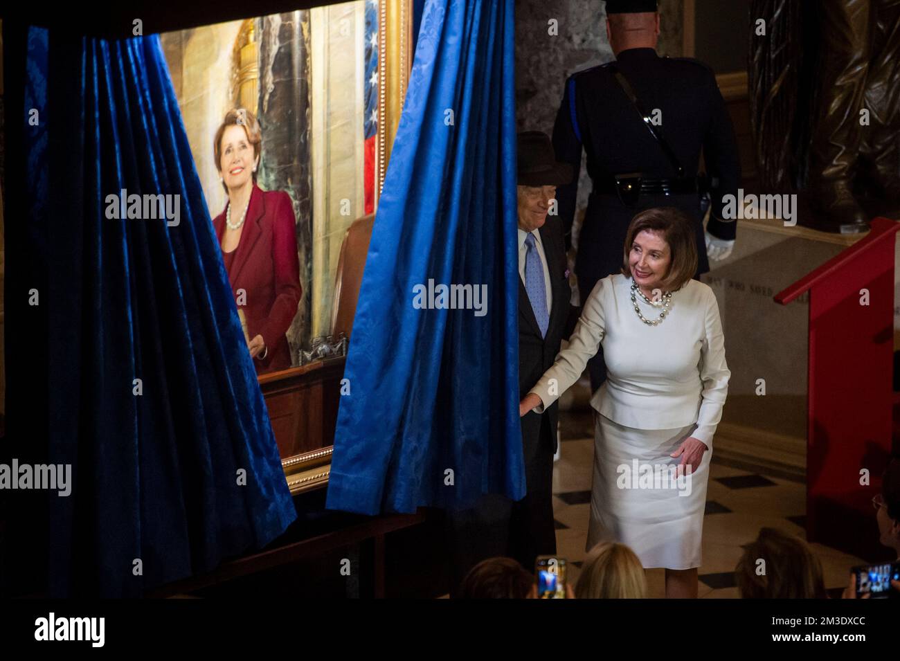 Washington, Vereinigte Staaten. 14th Dec, 2022. Speaker of the United States House of Representatives Nancy Pelosi (Democrat of California) is joined by her husband Paul Pelosi as she draws back the curtain to unveil her official portrait in Statuary Hall at the US Capitol in Washington, DC, Wednesday, December 14, 2022. Credit: Rod Lamkey/CNP/dpa/Alamy Live News Stock Photo