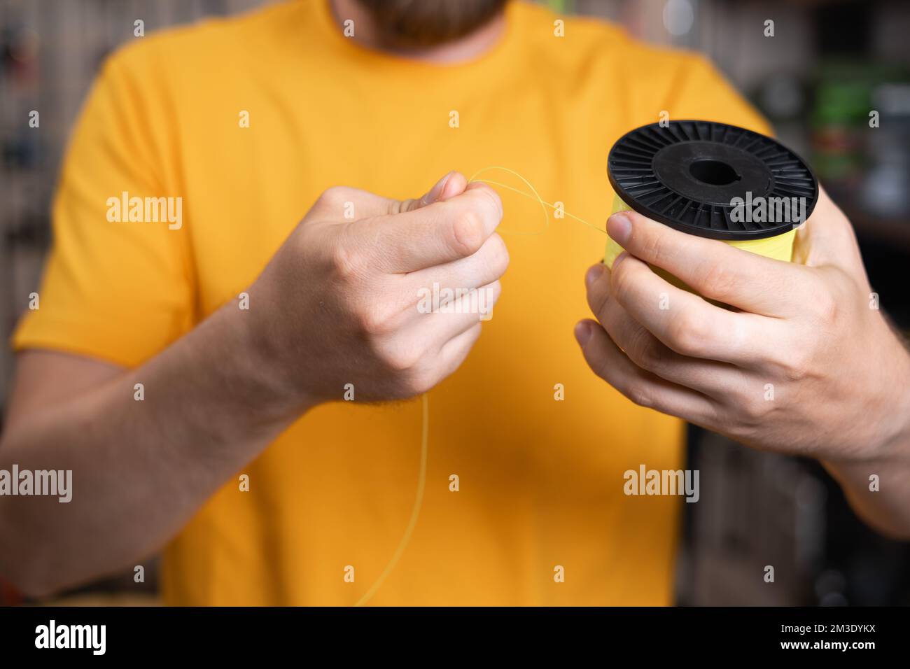 Close-up of a man choosing a fishing line in a fishing store, accessories for a fisherman Stock Photo