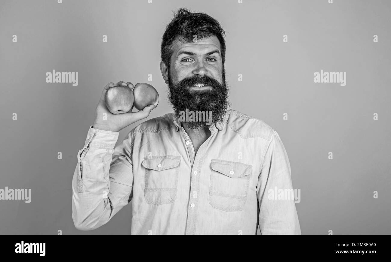Adopting vegetarian lifestyle brings health benefits. Healthy nutrition. Vegetarian lifestyle. Man with beard hipster hold apple fruit hand. Nutrition Stock Photo