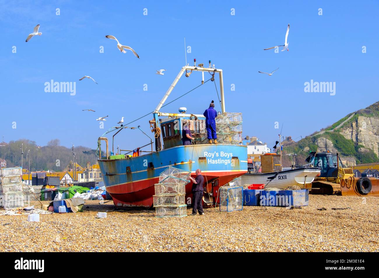 Trawler fishing boat loading nets, preparing to going to sea,, Hastings, UK Stock Photo