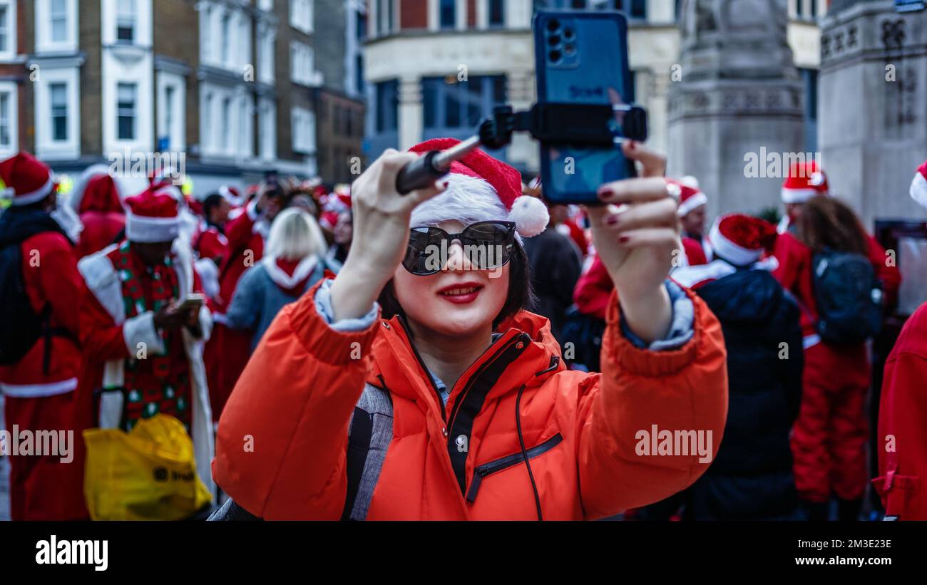 Smiley-selfie with fellow santas at santacon in London. Stock Photo