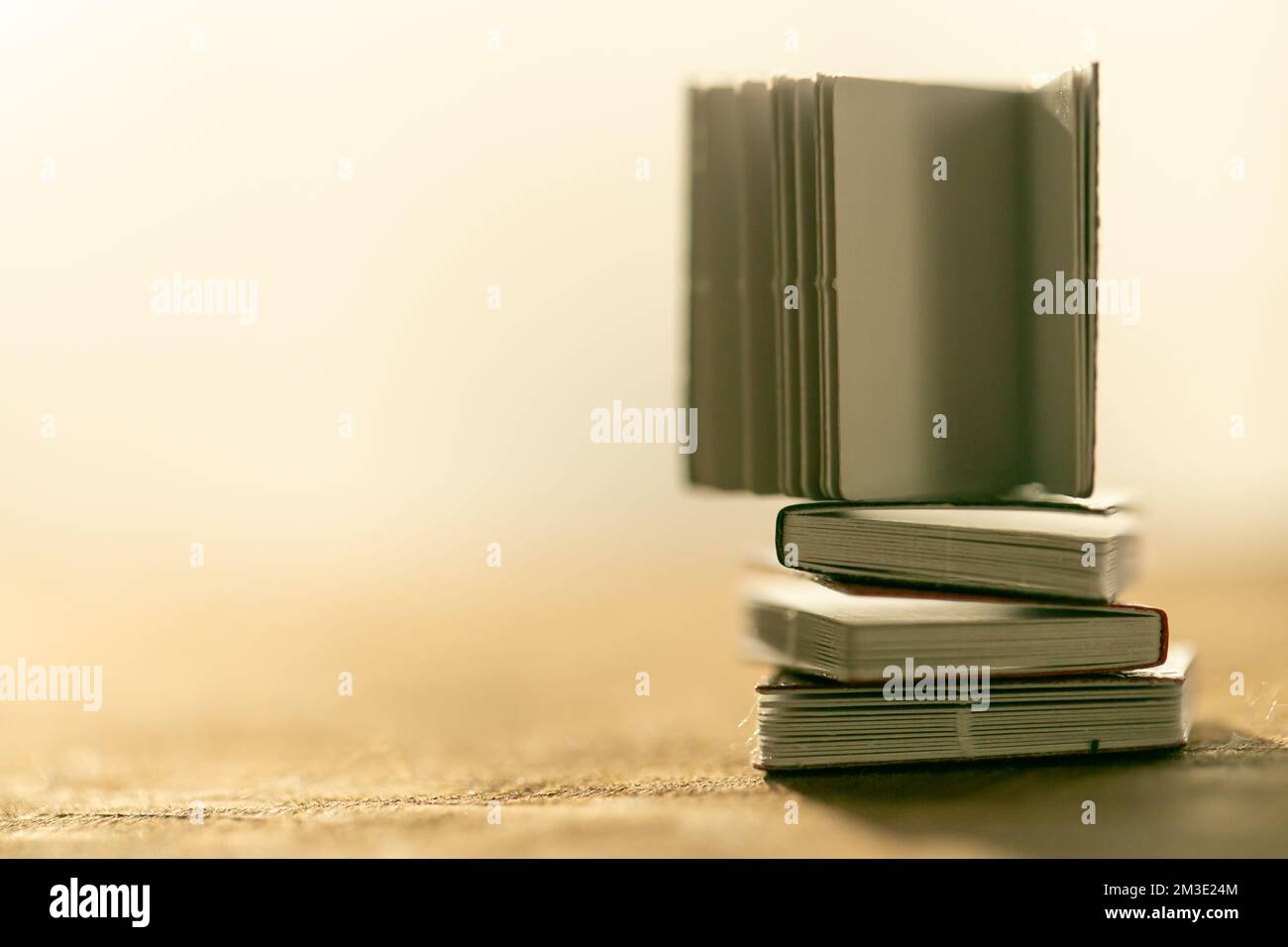 Reading books . stack of books on a wooden table on a light blurred ...