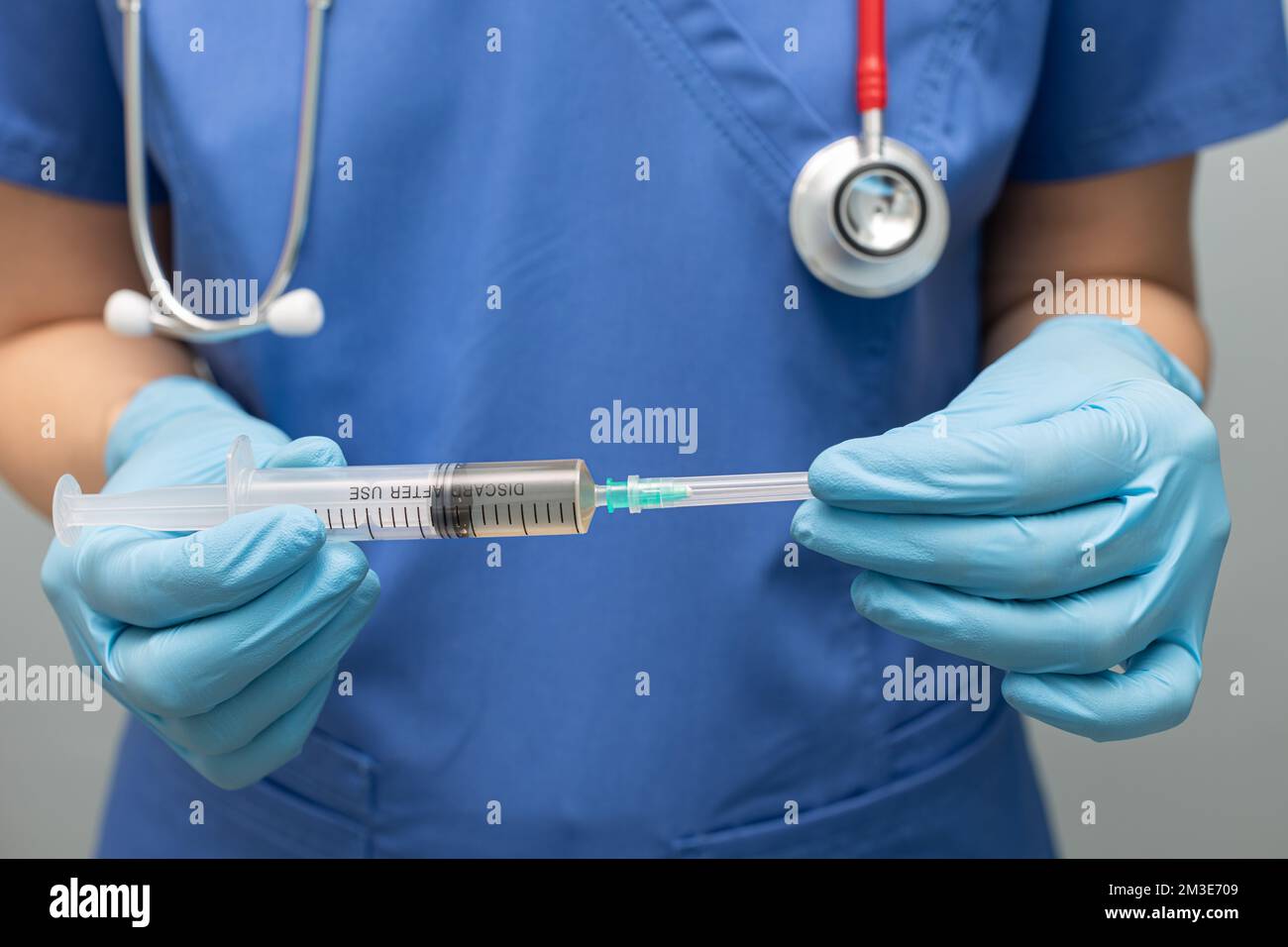 the doctor removes the cap from the syringe. syringe with needle Stock Photo Alamy