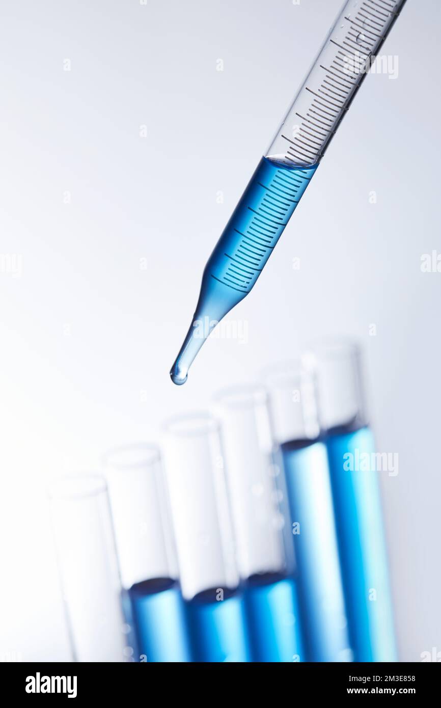 science lab with clear blue background and test tubes with blue ...