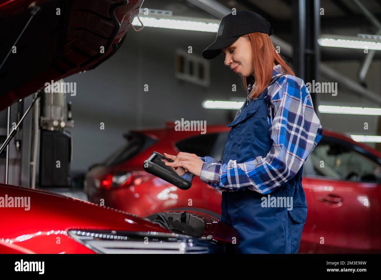 Caucasian female auto mechanic uses hi-res stock photography and images ...