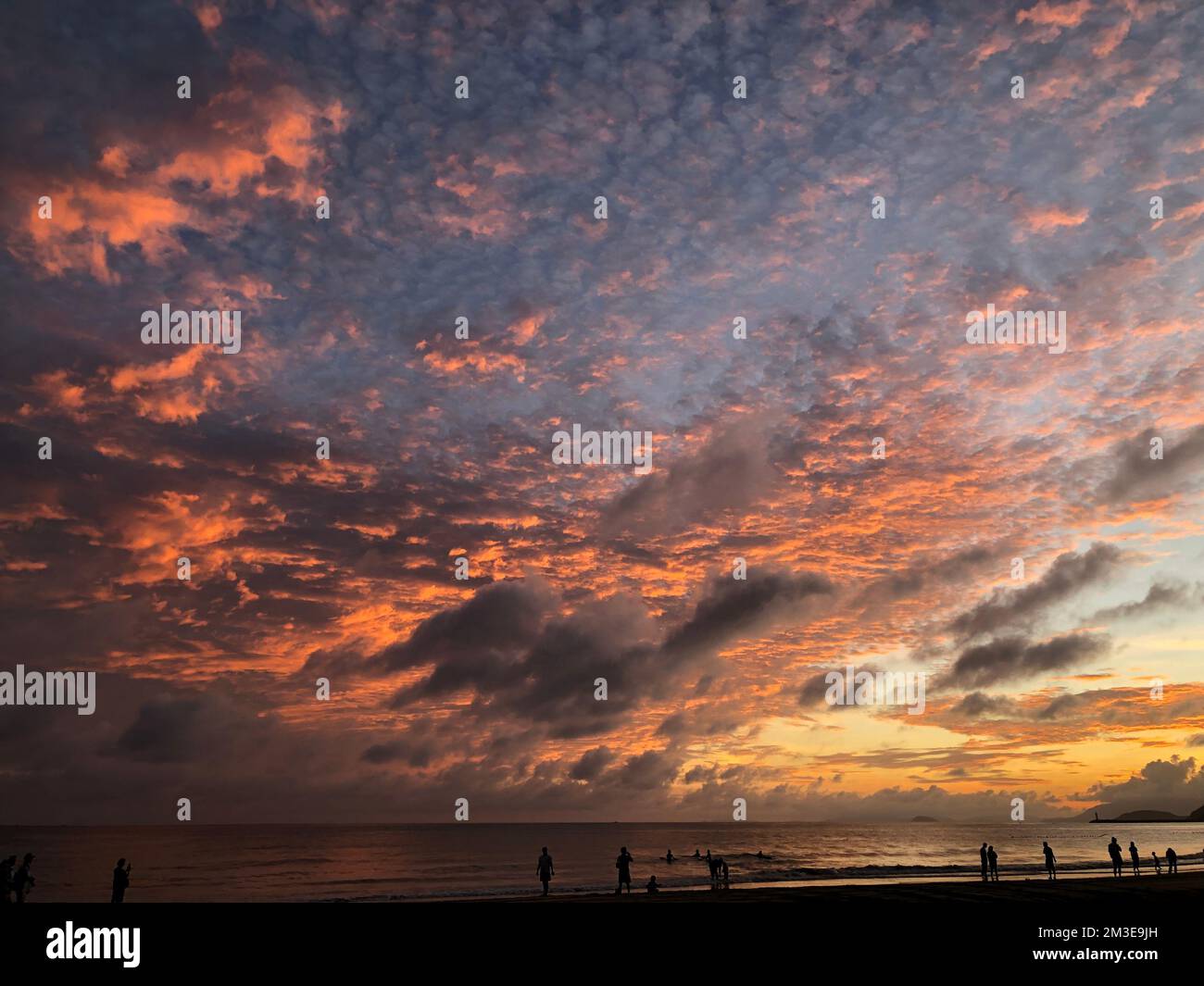 Colorful sunset with beautiful clouds by the beach Stock Photo - Alamy