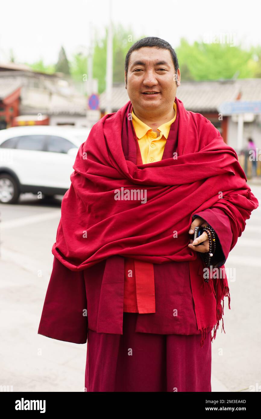 BEIJING- APRIL 28: Unidentified Monk posing on street on April 2013 in Beijing, China. Buddhist schools vary on the exact nature of the path to libera Stock Photo