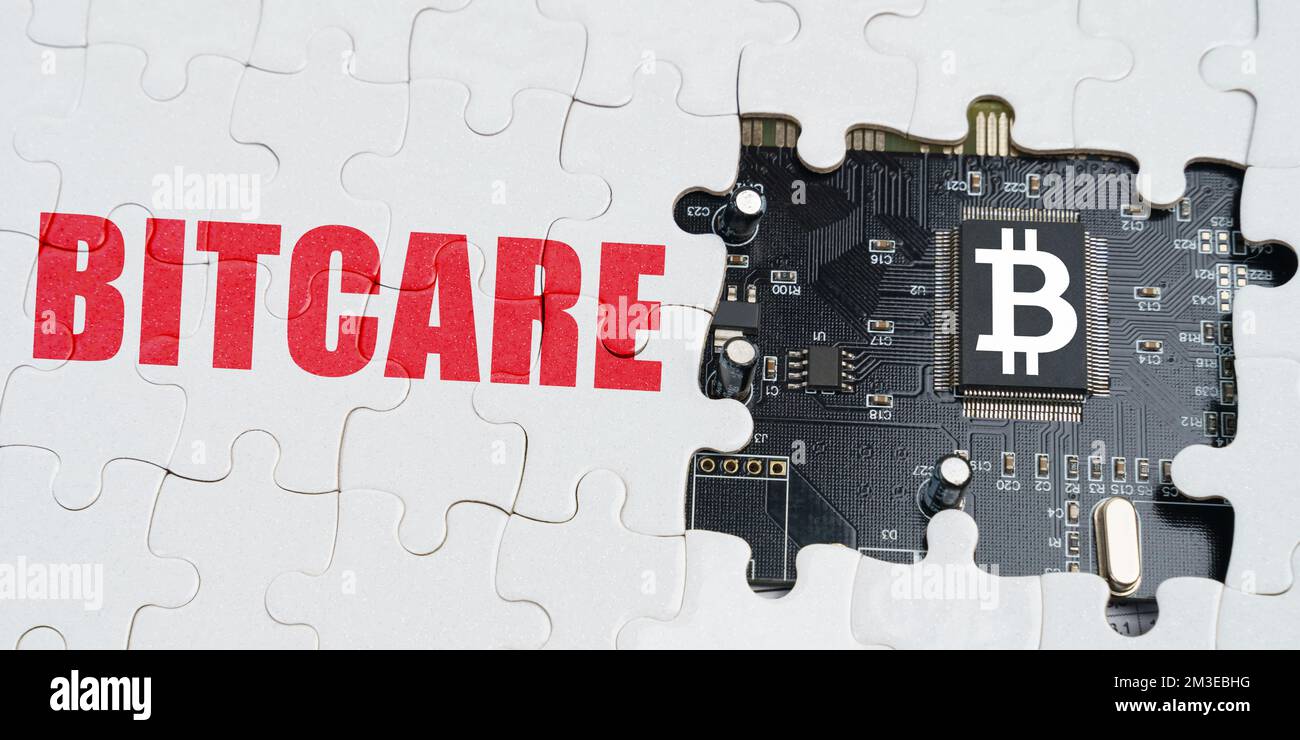 Business and technology concept. On the puzzles there is a processor with a bitcoin symbol and it says - Bitcare Stock Photo