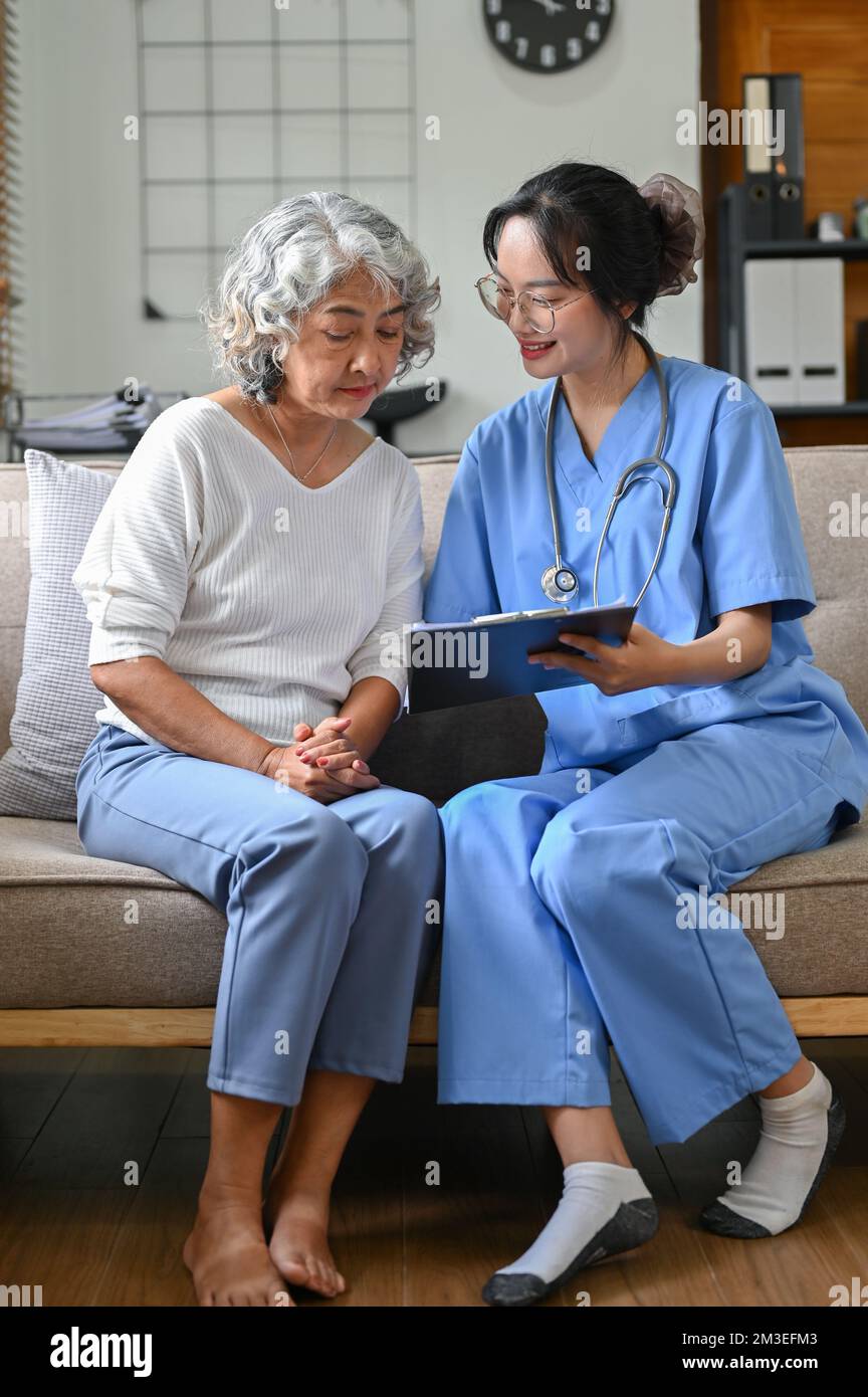 An Asian old woman visiting doctor in the hospital office, discussing medical checkup's result, consulting her medical treatment plan. Stock Photo