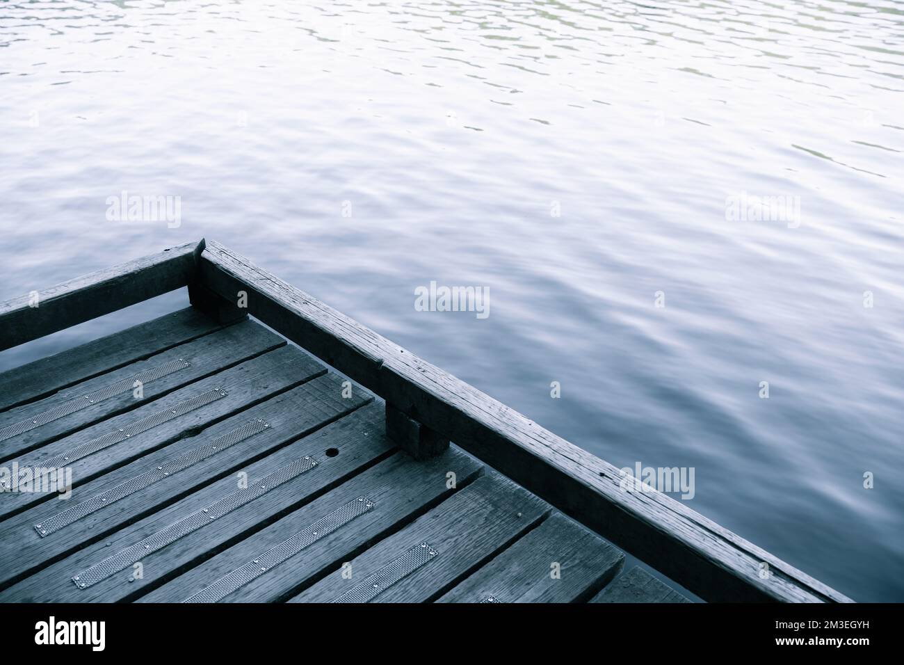 A part of a wooden dock with the blurred background of the lake Stock ...