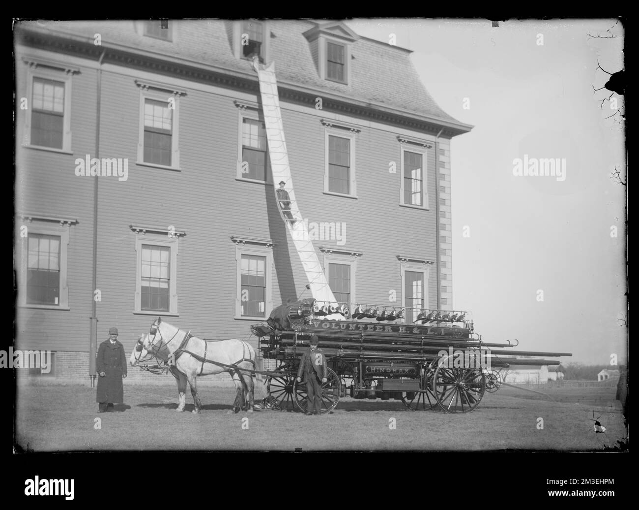 Man sliding down chute from 3rd story of Agricultural Hall and horse