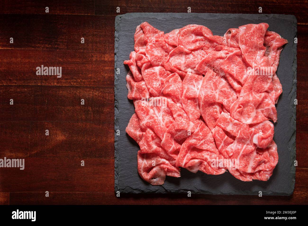 premium Japanese meat sliced wagyu marbled beef or pork on black slate ...