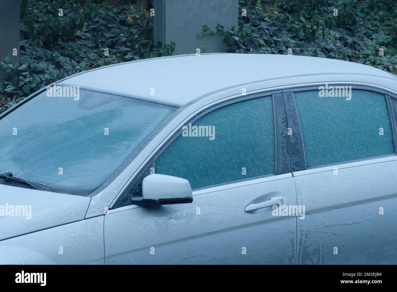 car covered in frost, frozen up vehicle,onset of winter,season,traffic problems, cold weather concept Stock Photo