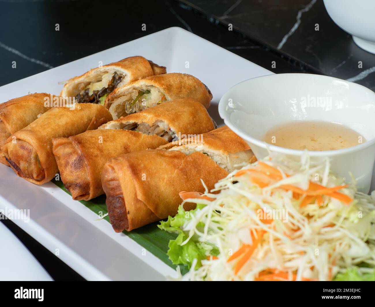 Deep fried spring rolls with mushrooms and glass noodles, a typical East and Southeast Asian appetizer. Stock Photo