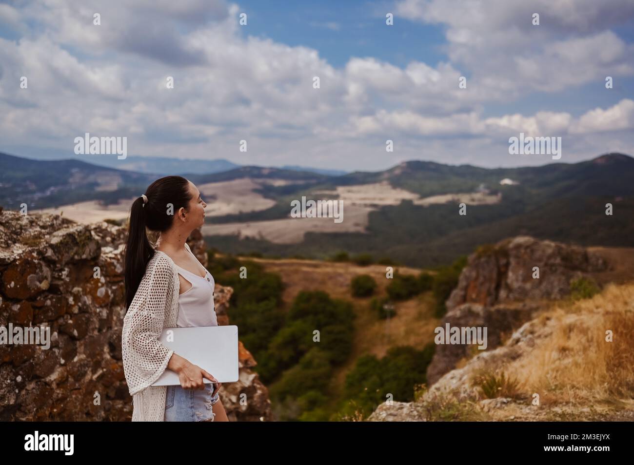 Young woman freelancer traveler working online anywhere outdoors using ...