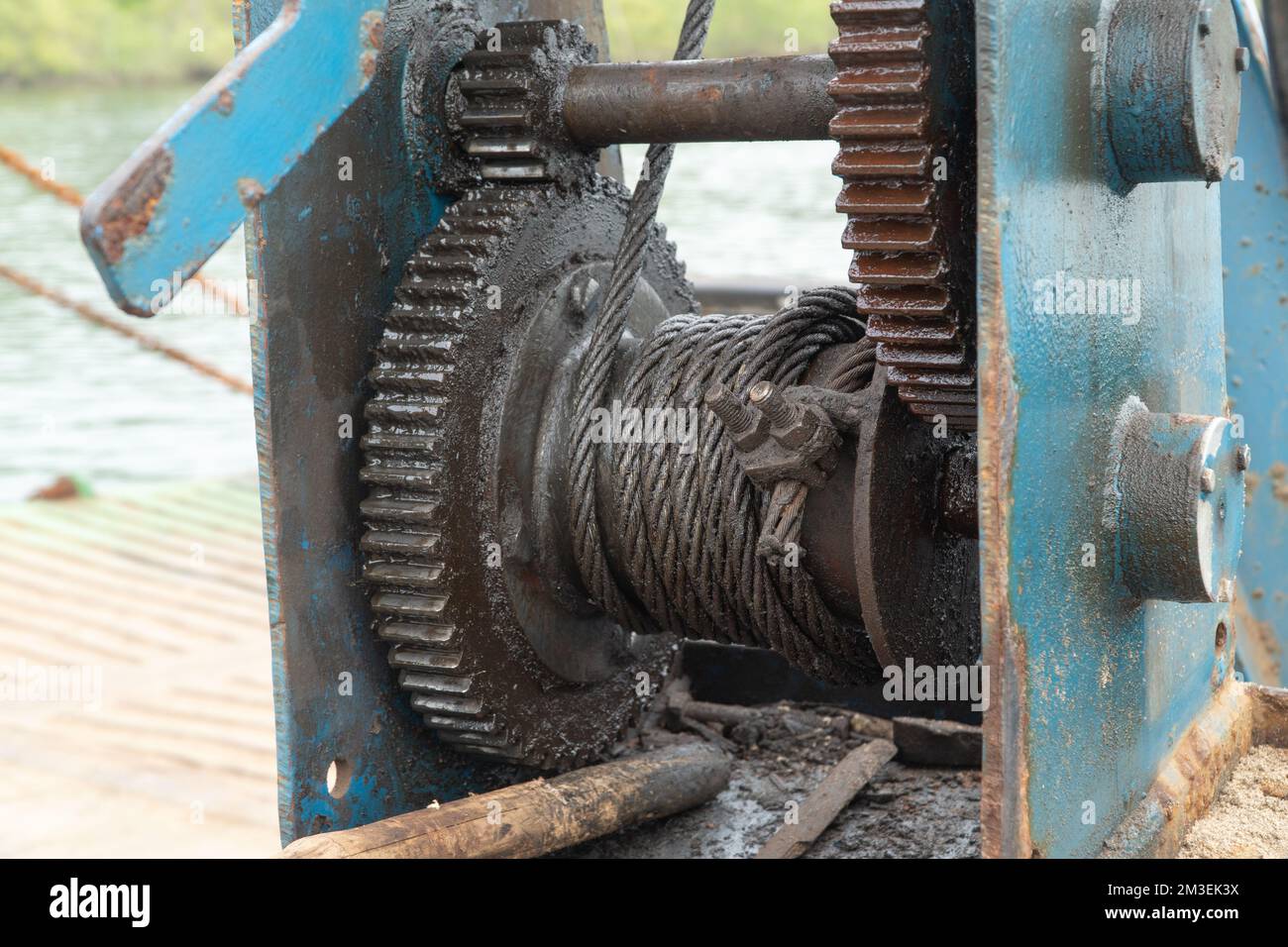 Stretching a steel cable on a flywheel on a ship Stock Photo